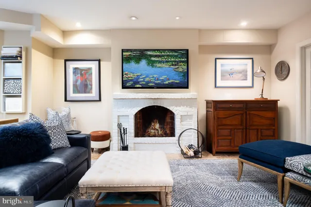 a living room with furniture a rug and a flat screen tv