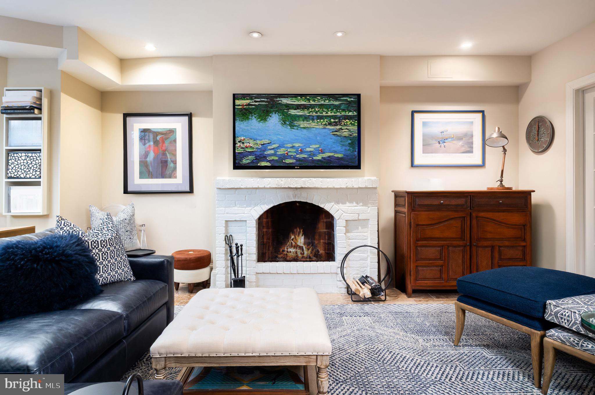 1335 Vermont Avenue Northwest Washington, DC 20005 - Photo 37 of 47 a living room with furniture a rug and a fireplace