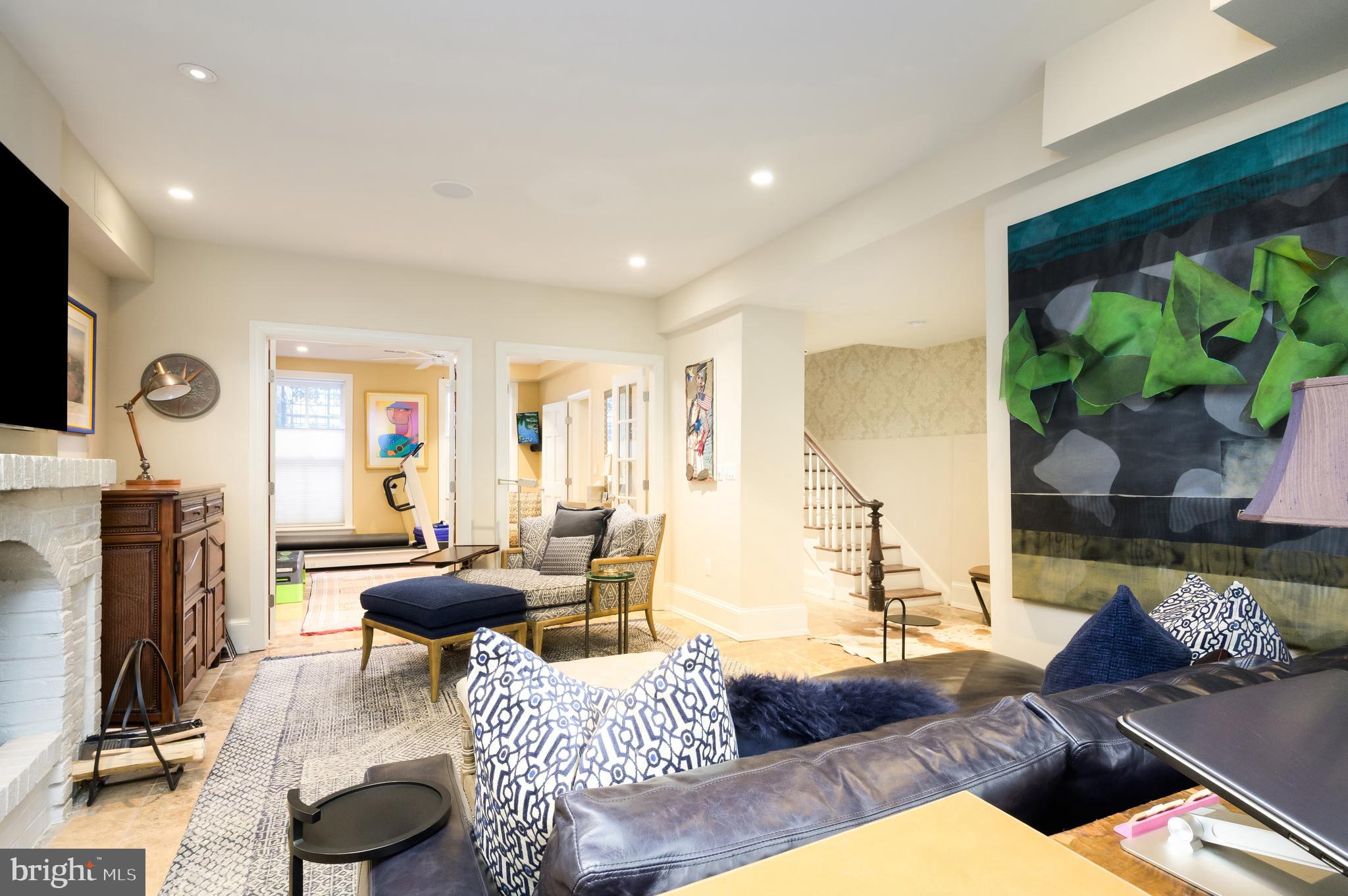 1335 Vermont Avenue Northwest Washington, DC 20005 - Photo 39 of 47 a living room with furniture a rug and a flat screen tv
