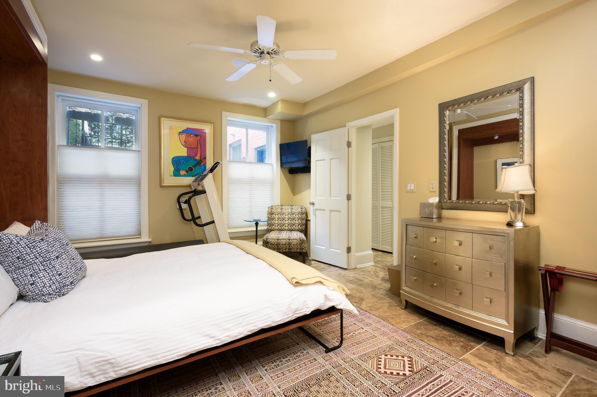 1335 Vermont Avenue Northwest Washington, DC 20005 - Photo 41 of 47 a bedroom with a bed a wall painting and a furniture