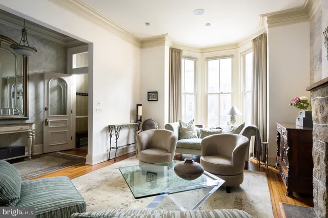 a living room with furniture rug and a window