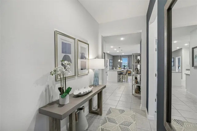 a dining room with furniture and a potted plant