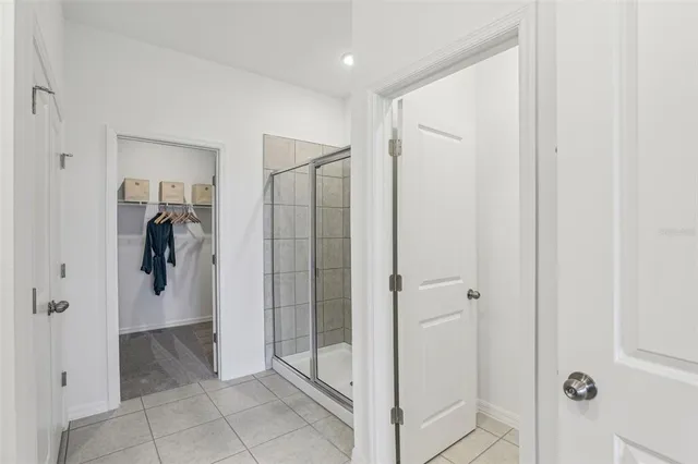 a bathroom with a shower and a glass door