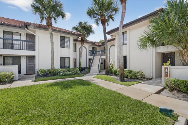 a front view of house and yard with green space