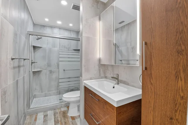 a bathroom with a sink toilet a shower and a mirror