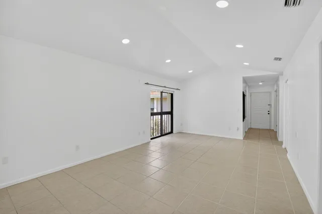 an empty room with closet and windows