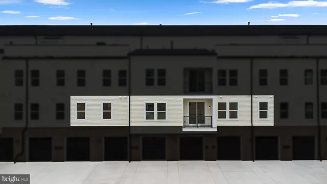 a front view of a building with many windows