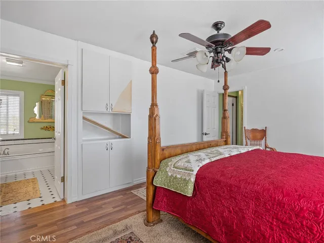 a hallway with a baby crib a rug and a chandelier