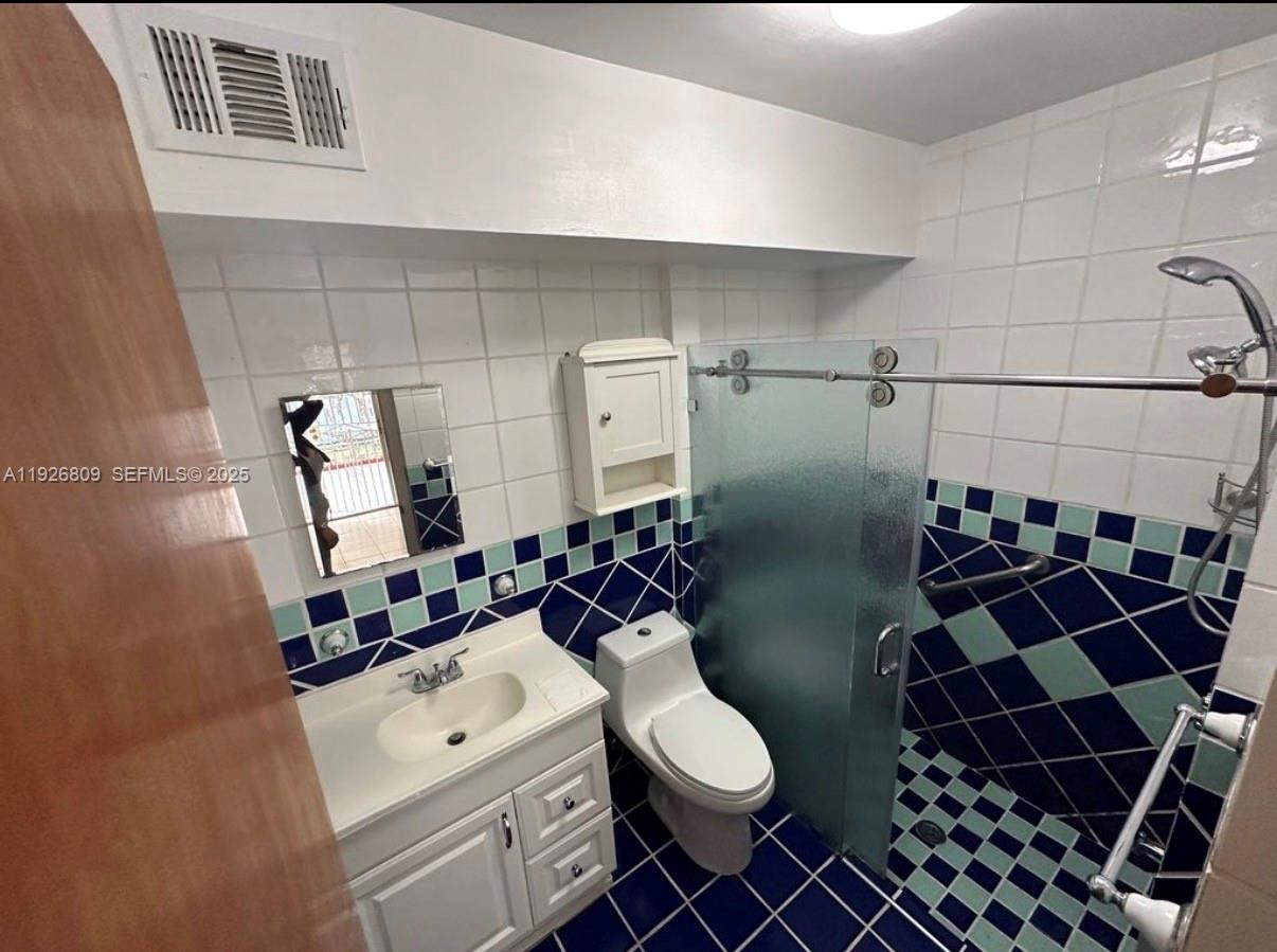 a bathroom with a toilet a sink and shower