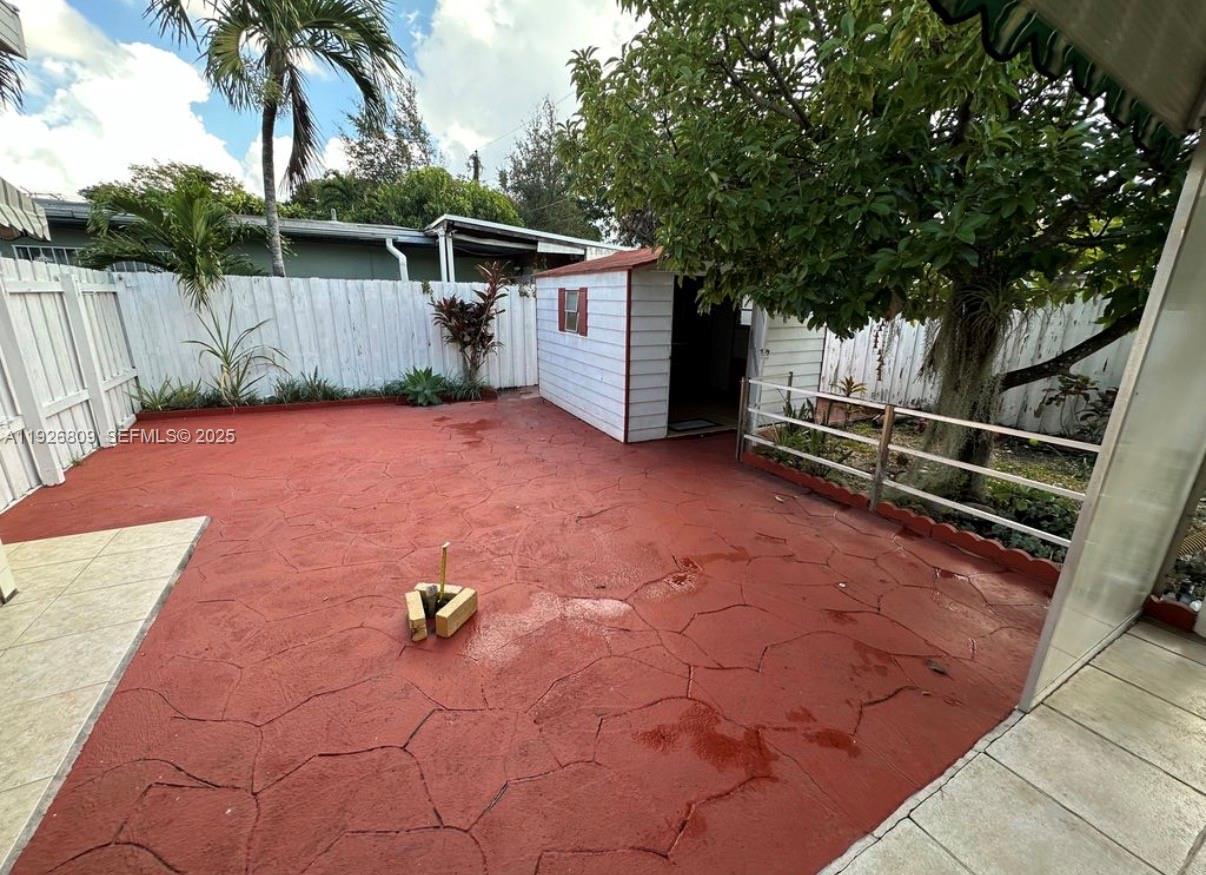 3894 Northwest 5th Street, Unit 3 Miami, FL 33126 - Photo 9 of 10 a backyard of a house with portable swimming pool and outdoor seating