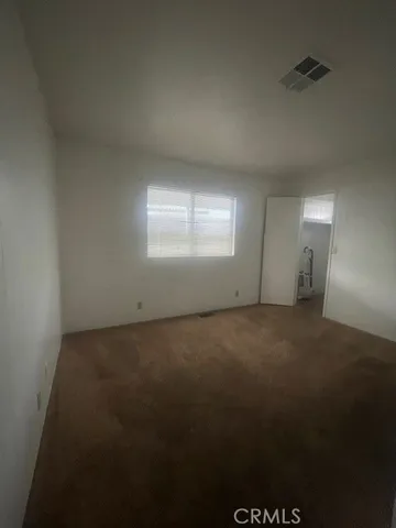 an empty room with a empty space and windows
