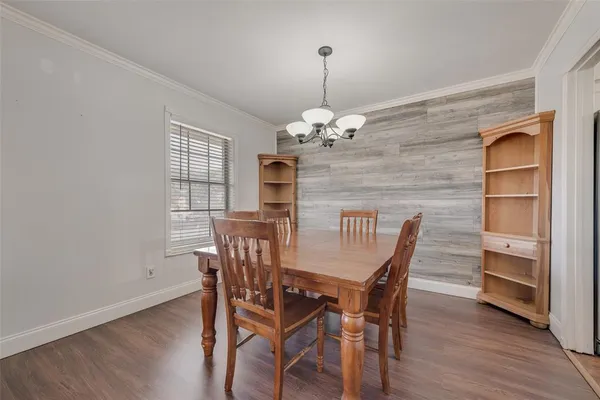 a view of a dining room with furniture wooden floor and chandelier