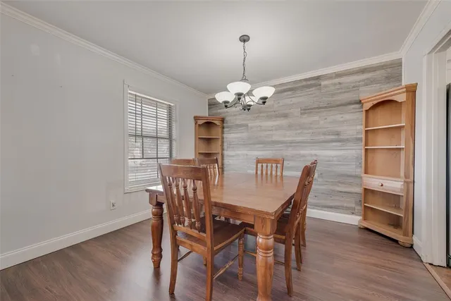 a view of a dining room with furniture wooden floor and chandelier