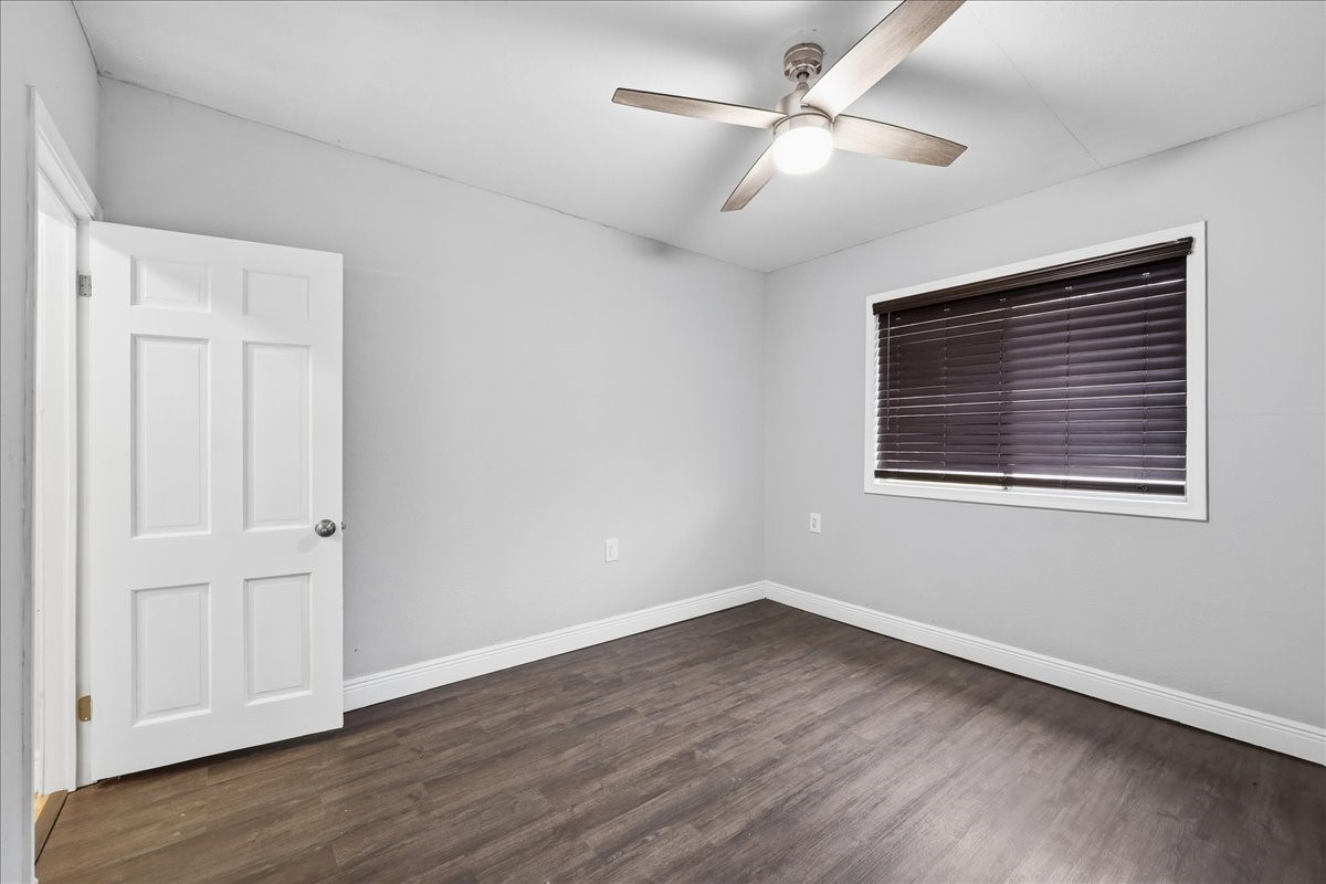 1415 Beagle Road Orange, TX 77632 - Photo 11 of 23 a view of empty room with wooden floor and ceiling fan
