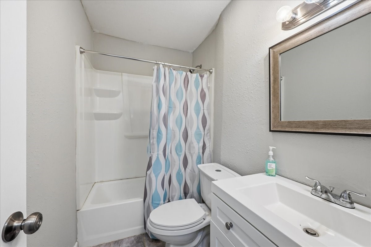 1415 Beagle Road Orange, TX 77632 - Photo 16 of 23 a bathroom with a sink toilet and shower