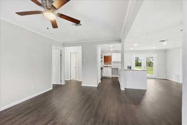 a view of a kitchen with wooden floor and a kitchen