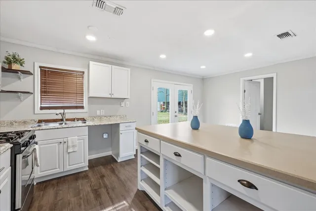 a kitchen with counter top space sink and stove