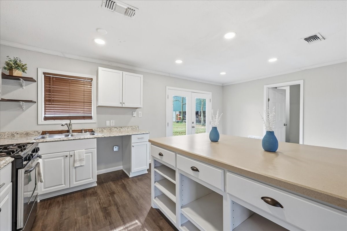1415 Beagle Road Orange, TX 77632 - Photo 10 of 23 a kitchen with counter top space sink and stove