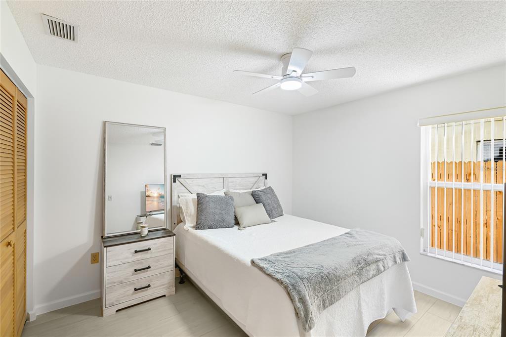 4537 South Lockwood Ridge Road Sarasota, FL 34231 - Photo 14 of 22 a bedroom with a large bed and a window