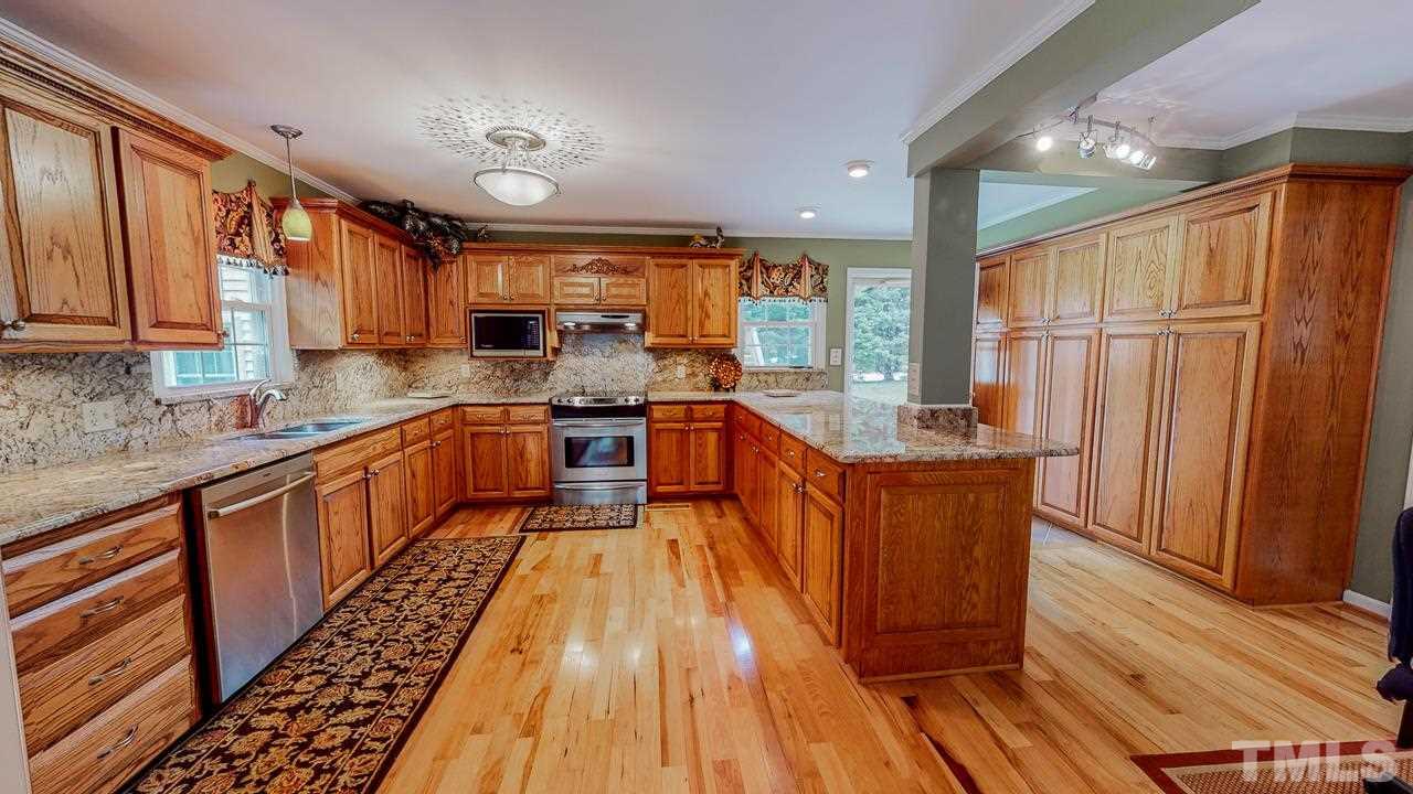 10 Canterbury Drive Roxboro, NC 27573 - Photo 2 of 30 a kitchen with stainless steel appliances granite countertop wooden cabinets a sink and a stove