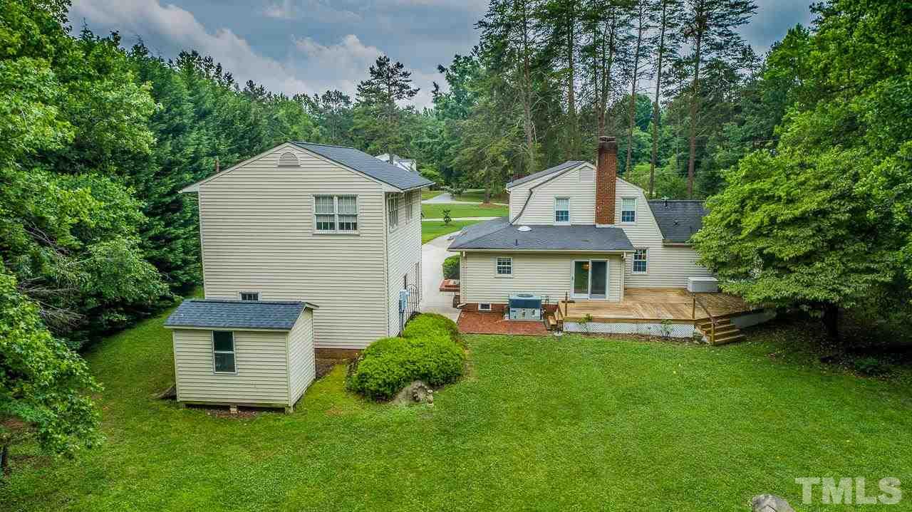 10 Canterbury Drive Roxboro, NC 27573 - Photo 15 of 30 a front view of a house with a garden and trees