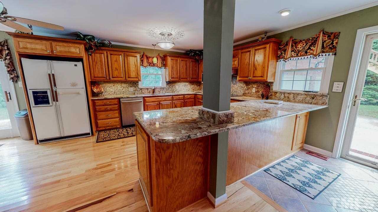 10 Canterbury Drive Roxboro, NC 27573 - Photo 3 of 30 a kitchen with stainless steel appliances granite countertop a sink stove and refrigerator
