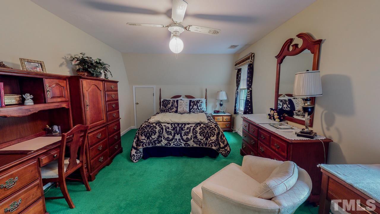 10 Canterbury Drive Roxboro, NC 27573 - Photo 23 of 30 a bedroom with a bed and a chandelier