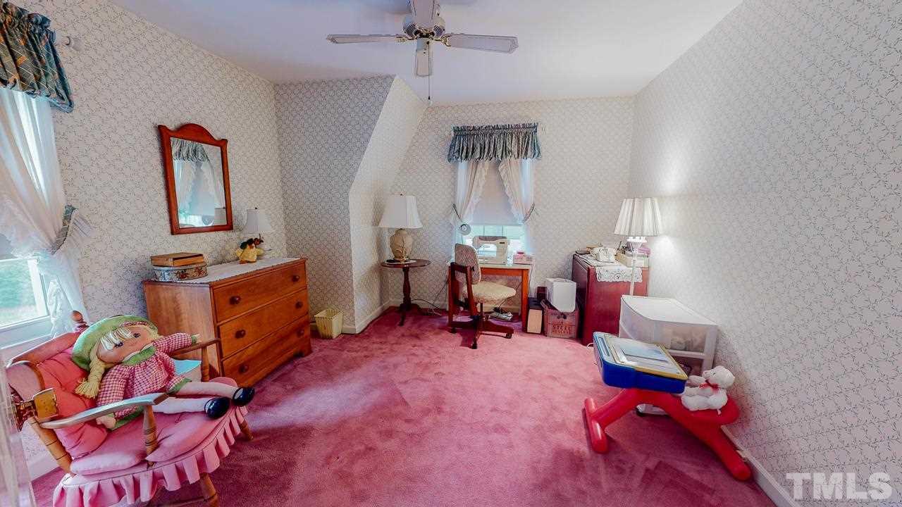 10 Canterbury Drive Roxboro, NC 27573 - Photo 24 of 30 a bedroom with furniture and a gym equipment