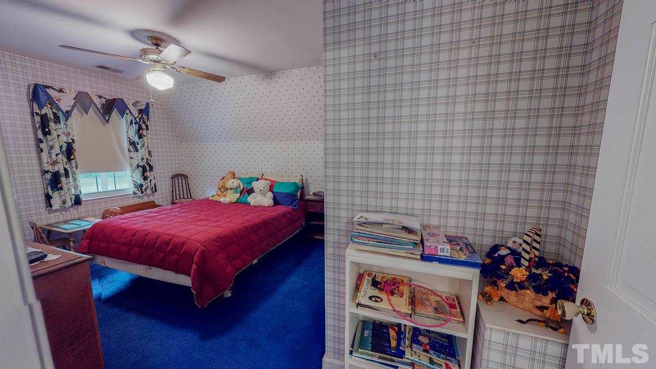 10 Canterbury Drive Roxboro, NC 27573 - Photo 25 of 30 a bed room with a bed and a book shelf