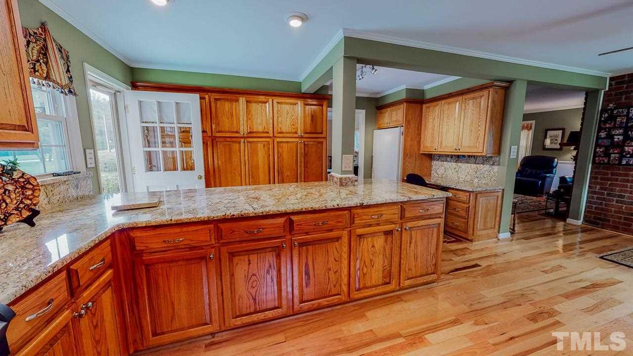 10 Canterbury Drive Roxboro, NC 27573 - Photo 4 of 30 a kitchen with stainless steel appliances granite countertop wooden cabinets a refrigerator and a sink