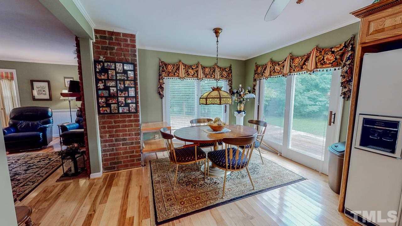 10 Canterbury Drive Roxboro, NC 27573 - Photo 5 of 30 a dining room with furniture a chandelier and wooden floor