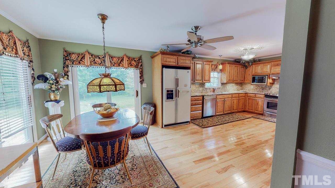 10 Canterbury Drive Roxboro, NC 27573 - Photo 6 of 30 a view of a dining room and livingroom with furniture wooden floor a rug a chandelier