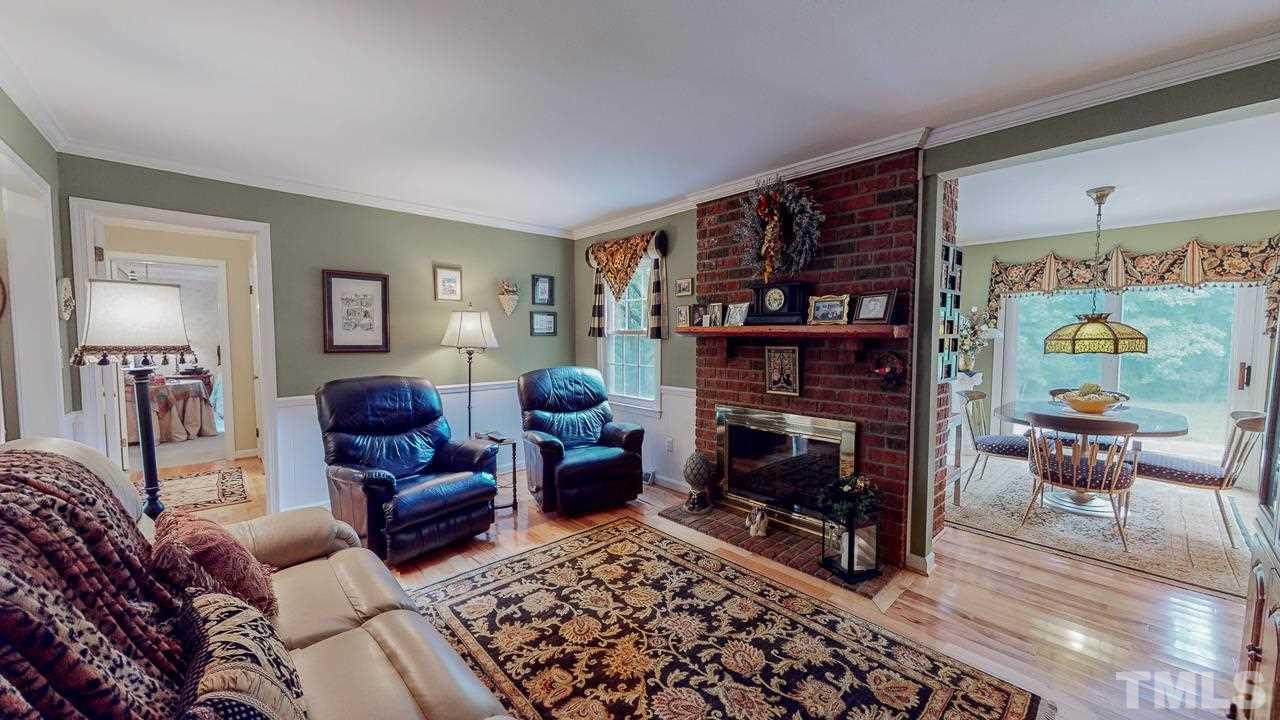 10 Canterbury Drive Roxboro, NC 27573 - Photo 7 of 30 a living room with furniture a rug and a fireplace