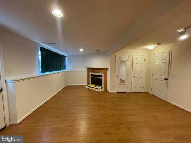 a view of an empty room with a fireplace