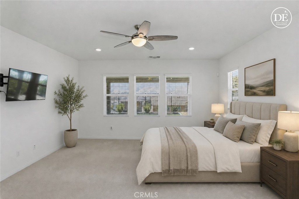 21159 Blue Jeans Court Riverside, CA 92507 - Photo 37 of 63 a spacious bedroom with a large bed and a chandelier