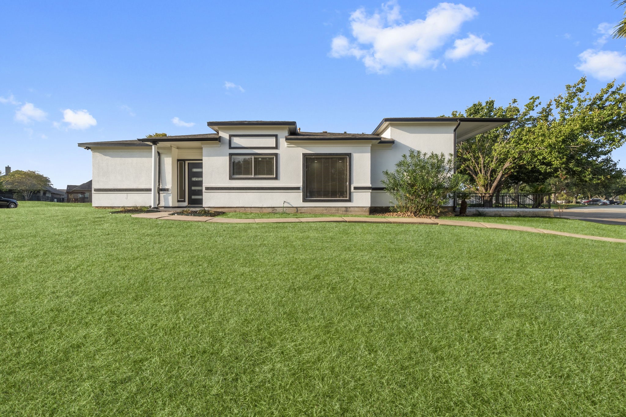 a front view of a house with a garden and yard