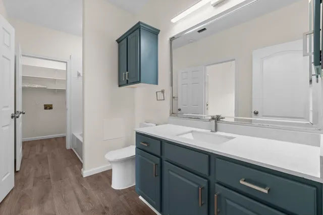 a view of a livingroom with wooden floor and a ceiling fan
