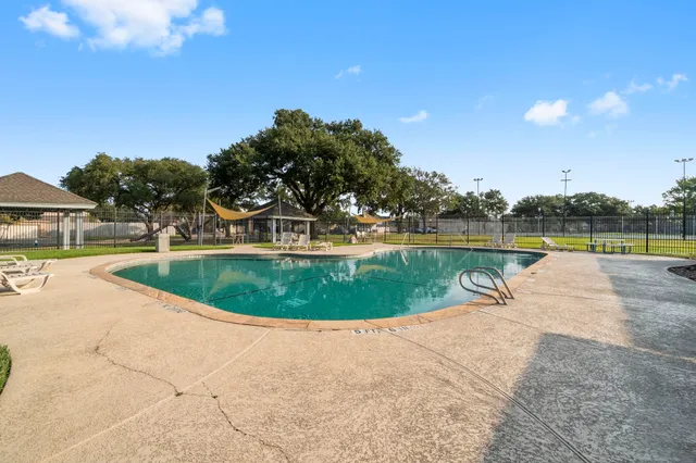 a view of a swimming pool with an outdoor seating and plants
