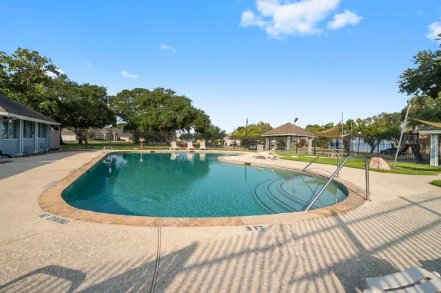 a view of a swimming pool with a patio