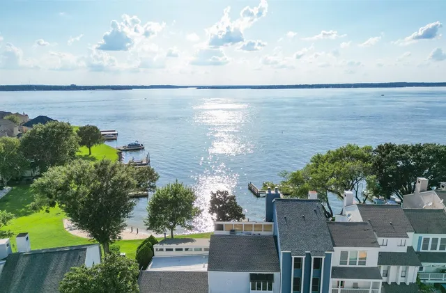 an aerial view of a house with a lake view