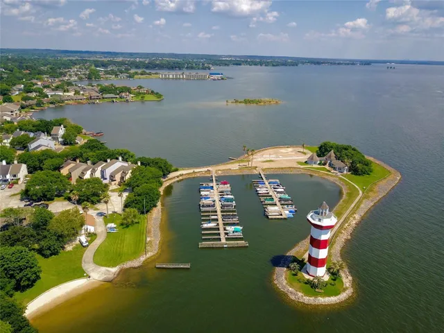a blue swimming pool with outdoor seating and lake view