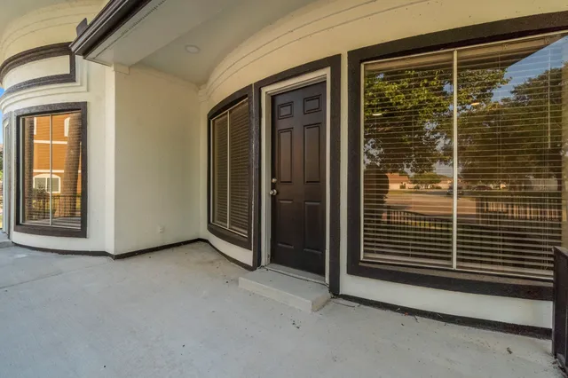 a view of an entryway with wooden floor and door