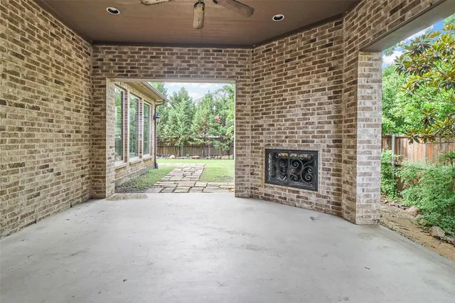 a view of an empty room with a fireplace and a window