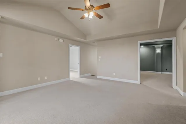 an empty room with closet and a chandelier fan