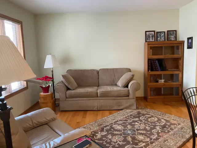 a living room with furniture a couch and a window