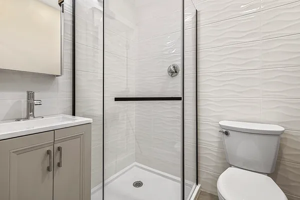a bathroom with a toilet sink and shower