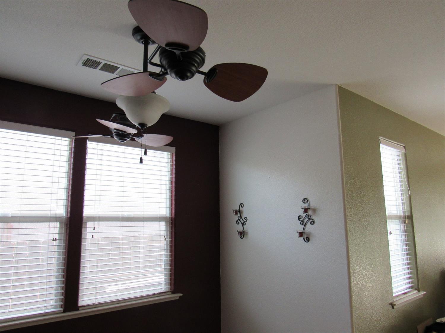 2141 Sheldon Court Reedley, CA 93654 - Photo 9 of 22 A unique dual fan with light fixture over your dining room.