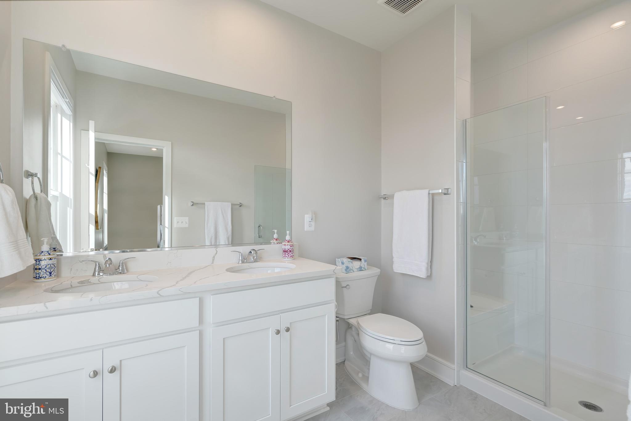 105 Checkerspot Way White Post, VA 22663 - Photo 26 of 37 a bathroom with a granite countertop toilet a sink and a mirror