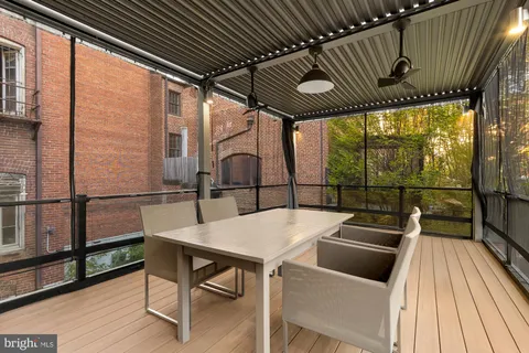 a view of a chairs and table in the balcony