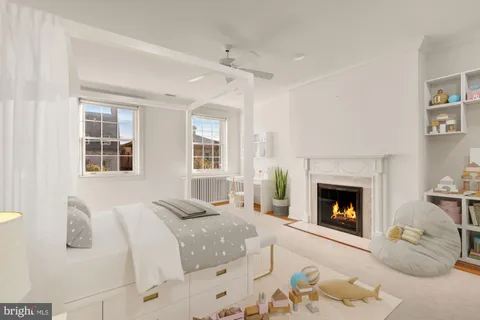 a bedroom with furniture and a fireplace